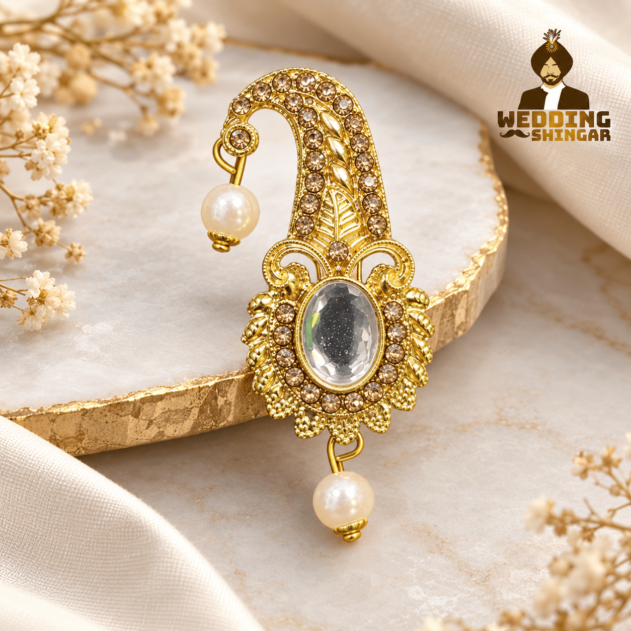 Golden stone-studded Safa Kalgi with oval centrepiece and pearl drops for wedding baratis and guests